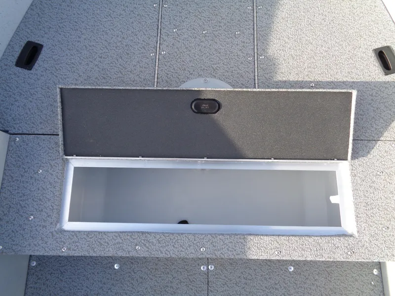 Slide: The Image of 2025 Lund 1600 Fury Heritage boat storage compartment, open and empty, with textured flooring. - 11