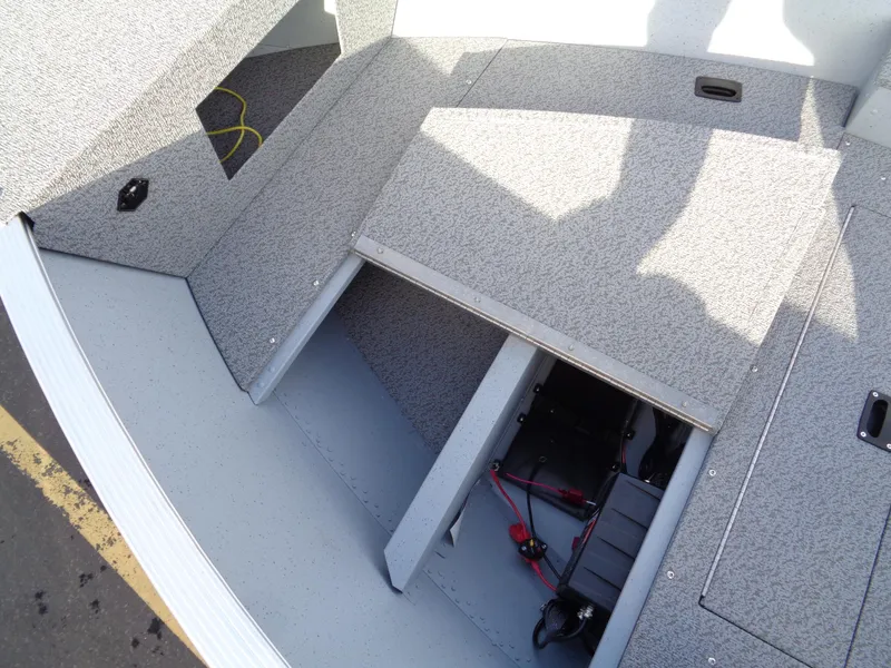 Slide: The Image of 2025 Lund 1600 Fury Heritage boat interior storage compartments and battery setup. - 14