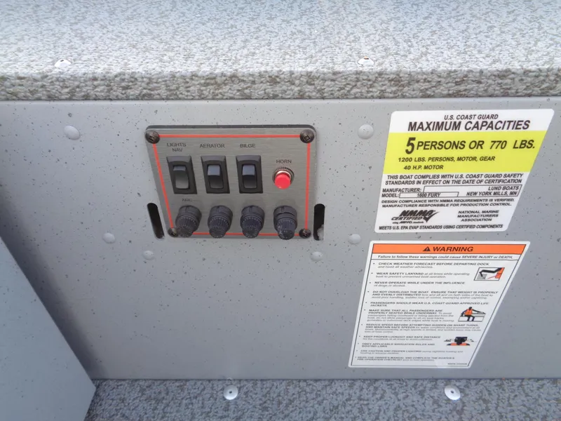 Slide: The Image of Control panel and capacity warning on 2025 Lund 1600 Fury Heritage boat. - 15
