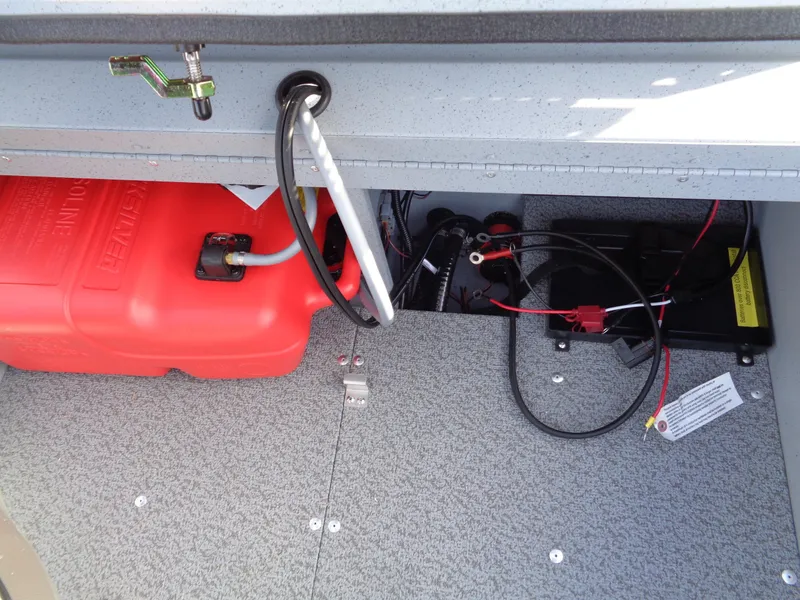 Slide: The Image of 2025 Lund 1600 Fury Heritage boat interior showing fuel tank and battery compartment. - 16