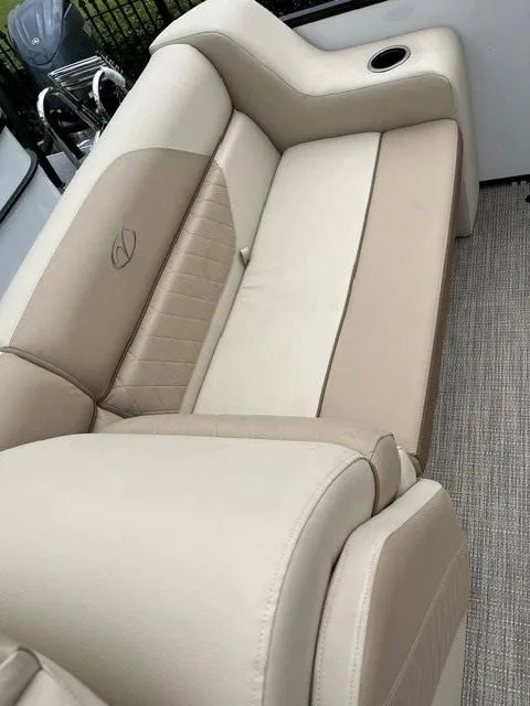 Slide: The Image of 2025 Veranda VISTA VIEW 22RC boat interior with beige seating and cup holder. - 10