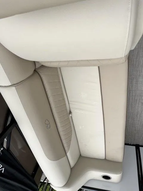 Slide: The Image of 2025 Veranda VISTA VIEW 22RC boat interior with beige seating and cup holder. - 9