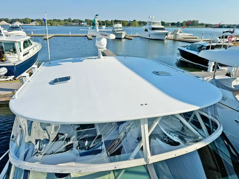 Slide: The Image of 1998 Trojan 440 Express yacht docked at marina with clear blue sky. - 10