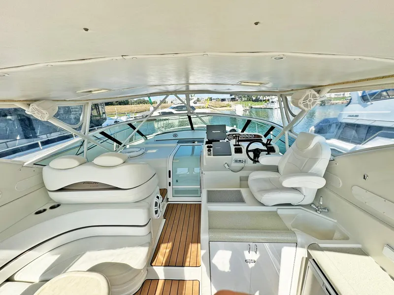 Slide: The Image of 1998 Trojan 440 Express yacht interior with white seating and wooden flooring. - 15