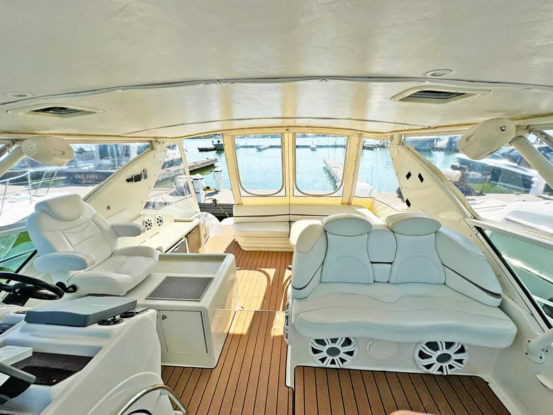 Slide: The Image of Luxurious interior of 1998 Trojan 440 Express yacht with white seating and wooden flooring. - 16
