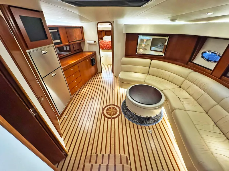 Slide: The Image of Luxurious interior of a 1998 Trojan 440 Express yacht with elegant wood flooring. - 23