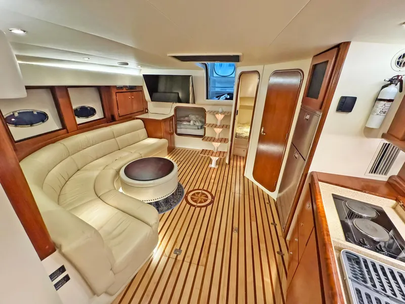 Slide: The Image of Luxurious interior of a 1998 Trojan 440 Express yacht with elegant wood and leather finishes. - 25