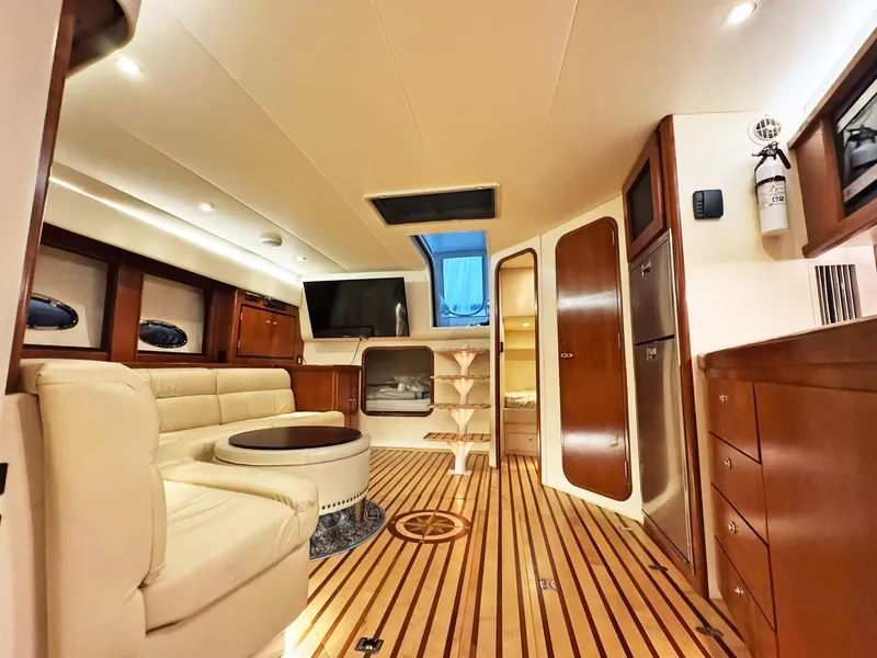 Slide: The Image of Luxurious interior of a 1998 Trojan 440 Express yacht with elegant wood flooring. - 26