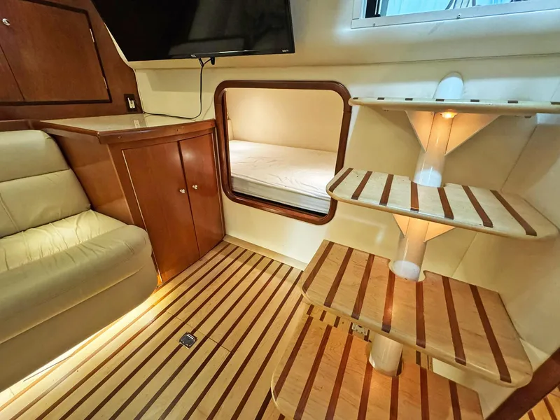 Slide: The Image of Luxurious interior of 1998 Trojan 440 Express yacht with wooden flooring and cozy seating. - 34