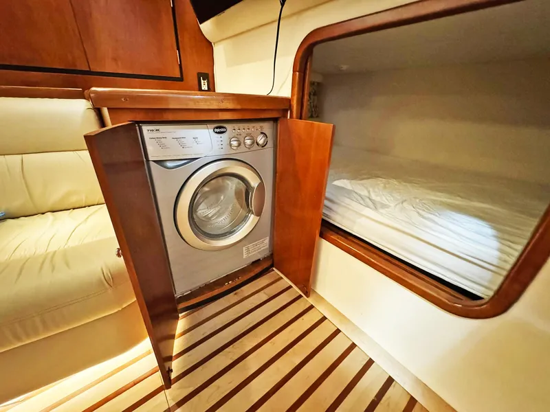Slide: The Image of 1998 Trojan 440 Express interior with washer and cozy sleeping area. - 36