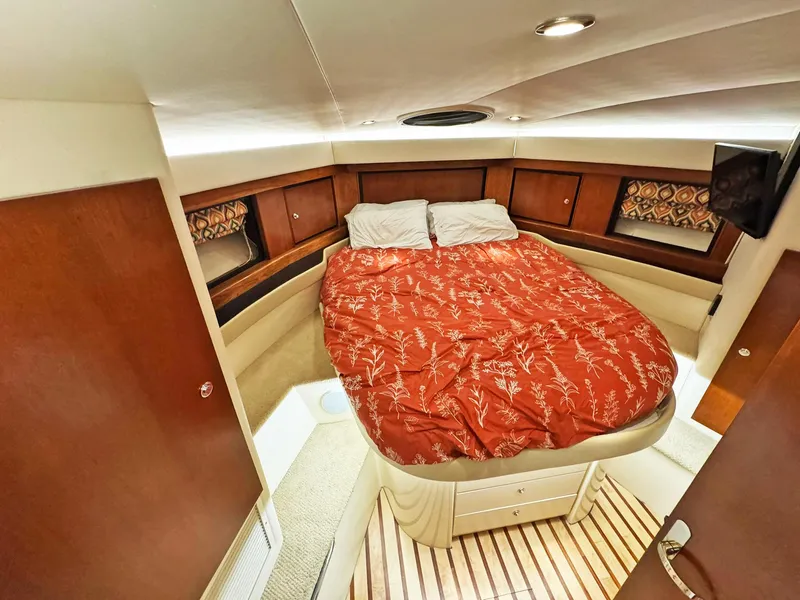 Slide: The Image of Luxurious cabin interior of a 1998 Trojan 440 Express yacht with a cozy bed. - 38