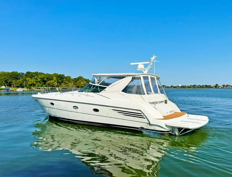 Slide: The Image of 1998 Trojan 440 Express yacht on calm water, clear blue sky background. - 5