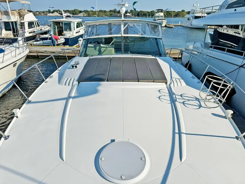 Slide: The Image of 1998 Trojan 440 Express yacht docked at marina, surrounded by other boats. - 8