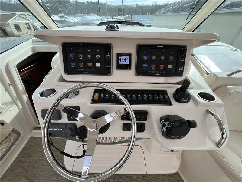 Slide: The Image of 2015 Grady-White Express 370 helm with dual displays and steering wheel. - 12