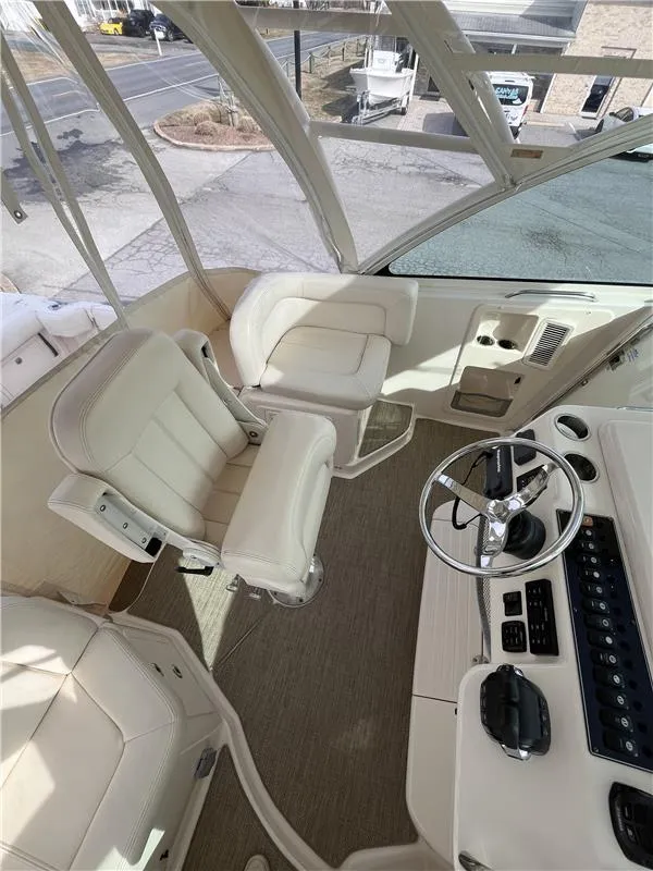 Slide: The Image of 2015 Grady-White Express 370 boat interior with helm, steering wheel, and seating. - 13