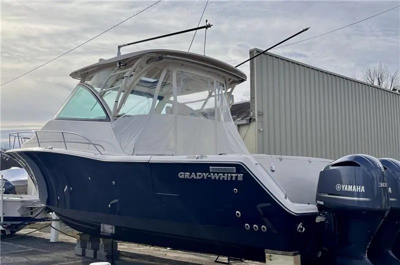 Slide: The Image of 2015 Grady-White Express 370 boat with Yamaha engines, docked outdoors. - 2