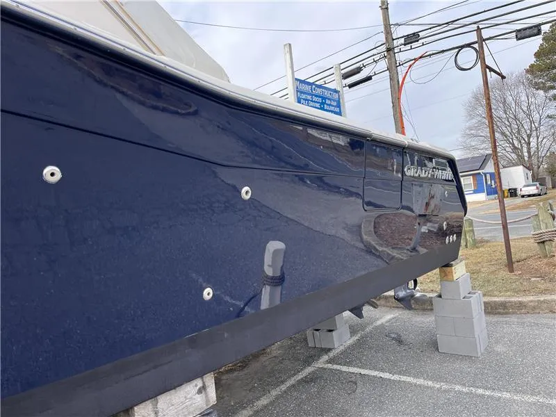 Slide: The Image of 2015 Grady-White Express 370 boat on blocks, side view, blue hull. - 4