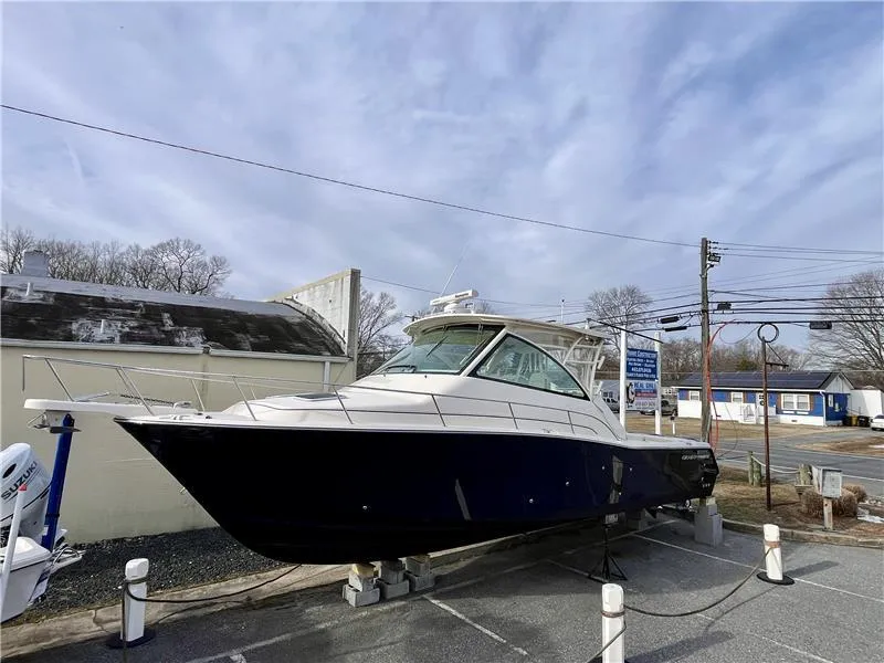 Slide: The Image of 2015 Grady-White Express 370 boat displayed outdoors on a cloudy day. - 5