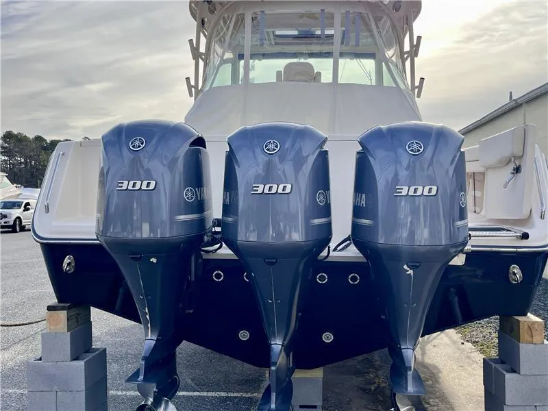 Slide: The Image of 2015 Grady-White Express 370 with triple Yamaha 300 engines, docked on blocks. - 6
