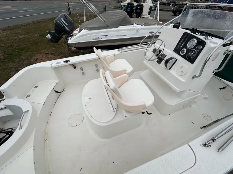 Slide: The Image of 2001 Trophy 1903 Center Console boat interior with steering wheel and seating. - 2