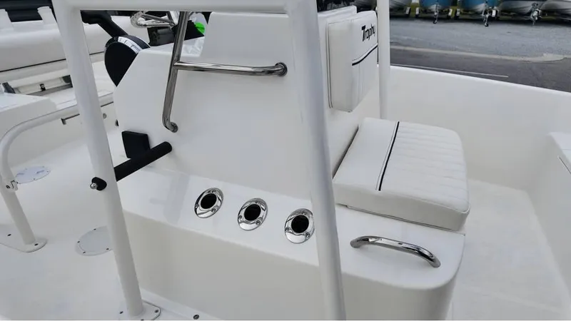 Slide: The Image of 2025 Bayliner T18 Limited Edition boat interior with white seating and control panel. - 15