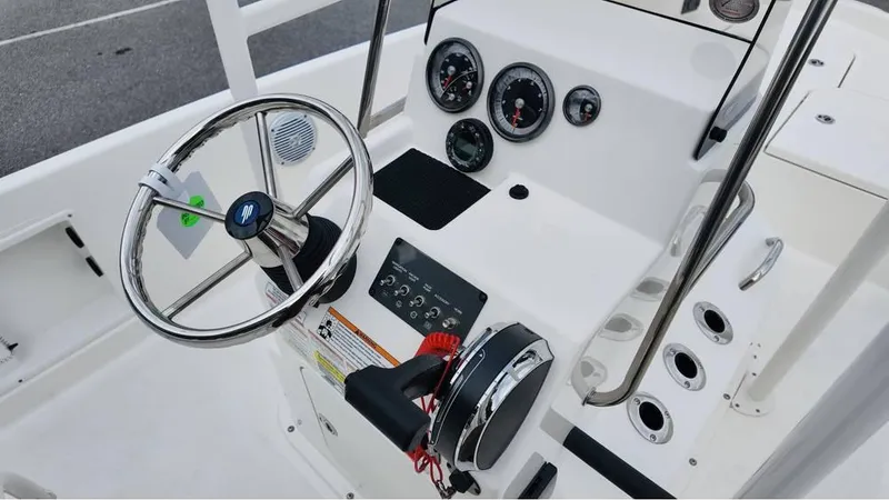 Slide: The Image of 2025 Bayliner T18 Limited Edition boat dashboard with steering wheel and control panel. - 19