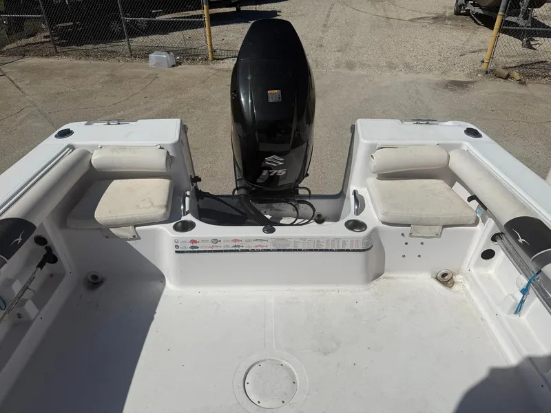 Slide: The Image of 2007 Pro-Line 21 Walkaround boat interior with seating and motor. - 10