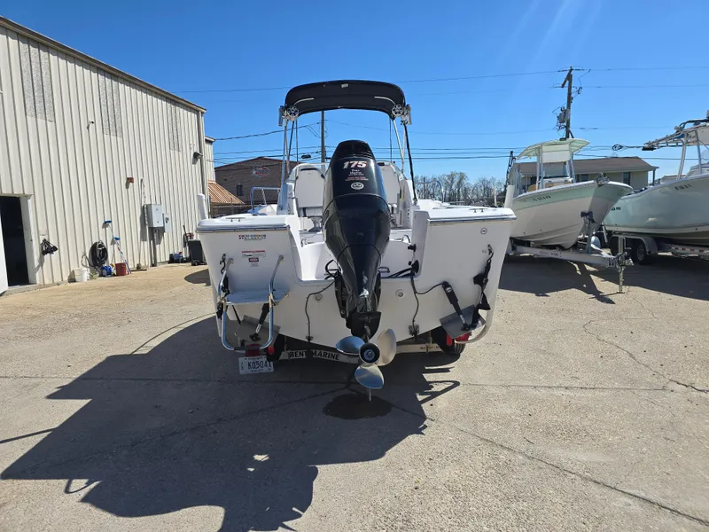 Slide: The Image of 2007 Pro-Line 21 Walkaround boat with outboard motor in a sunny marina. - 3