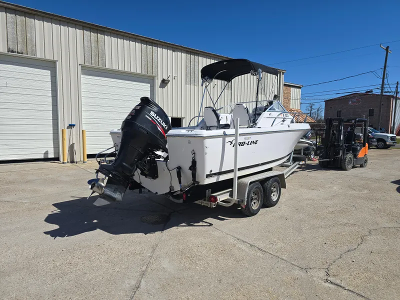 Slide: The Image of 2007 Pro-Line 21 Walkaround boat on trailer, parked outside industrial building. - 4
