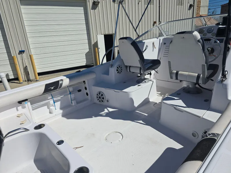 Slide: The Image of 2007 Pro-Line 21 Walkaround boat interior with seating and control panel. - 7