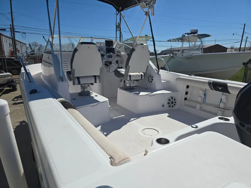 Slide: The Image of 2007 Pro-Line 21 Walkaround boat interior with seating and steering console. - 8