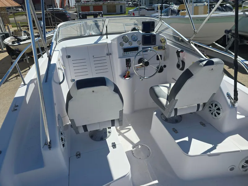 Slide: The Image of 2007 Pro-Line 21 Walkaround boat cockpit with steering wheel and seating. - 9