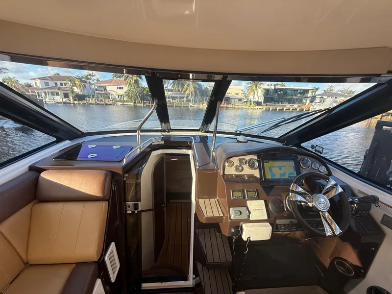 Slide: The Image of Interior view of 2015 Regal 35 Sport Coupe yacht cockpit with navigation controls. - 14