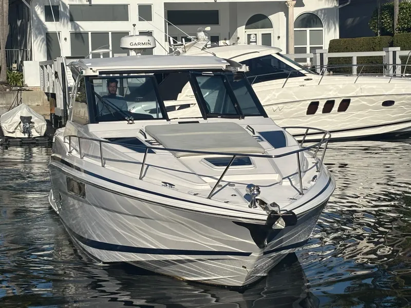 Slide: The Image of 2015 Regal 35 Sport Coupe boat docked in marina, front view. - 2