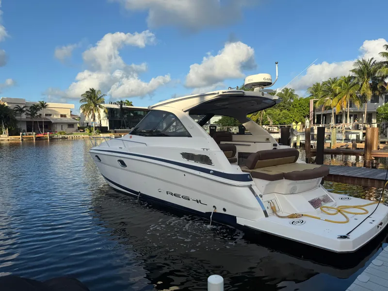 Slide: The Image of 2015 Regal 35 Sport Coupe yacht docked in a scenic marina. - 4