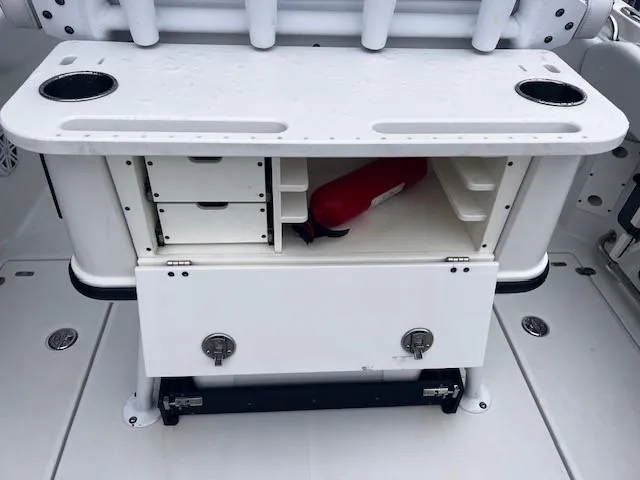 Slide: The Image of 2021 Blackfin 252 CC boat storage compartment with drawers and fire extinguisher. - 10