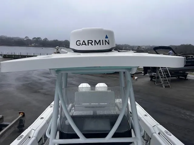 Slide: The Image of 2021 Blackfin 252 CC boat with Garmin radar on top, docked near a waterfront. - 13