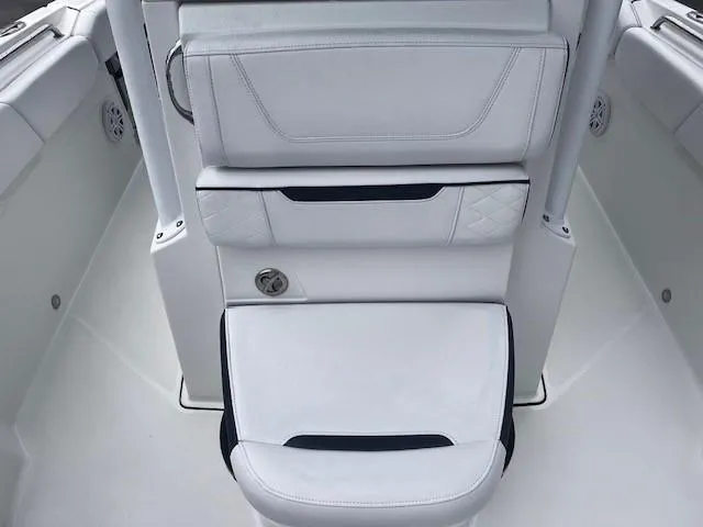 Slide: The Image of 2021 Blackfin 252 CC boat interior with white cushioned seating. - 18