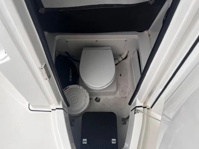 Slide: The Image of 2021 Blackfin 252 CC boat interior with compact marine toilet. - 19