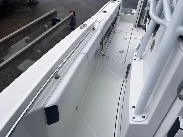 Slide: The Image of 2021 Blackfin 252 CC boat interior, showcasing sleek white deck and seating area. - 20
