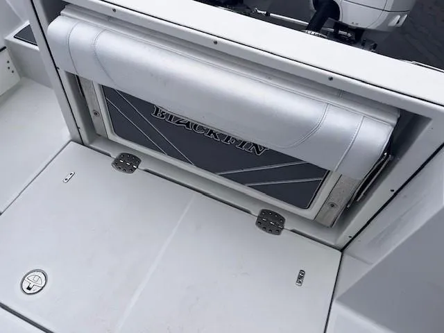Slide: The Image of 2021 Blackfin 252 CC boat interior with foldable seat and storage compartment. - 6
