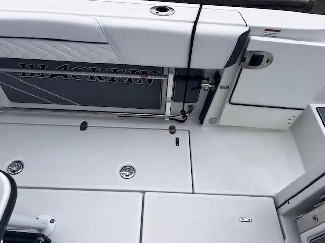 Slide: The Image of 2021 Blackfin 252 CC boat deck with storage compartments and sleek design. - 8