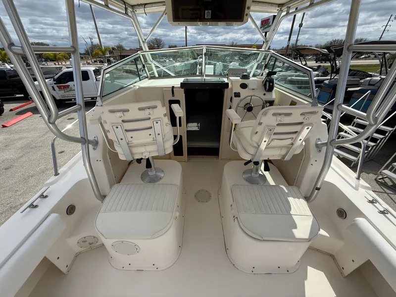 Slide: The Image of 2005 Parker 2510 Deep Vee Walkaround boat interior with dual seats and steering console. - 12
