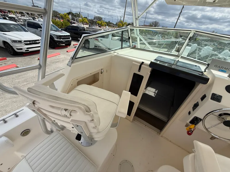 Slide: The Image of 2005 Parker 2510 Deep Vee Walkaround boat interior with helm and seating. - 13