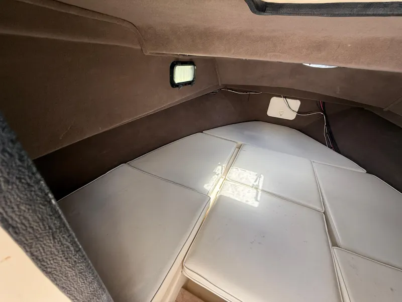 Slide: The Image of Interior cabin of 2005 Parker 2510 Deep Vee Walkaround boat with cushioned seating. - 18