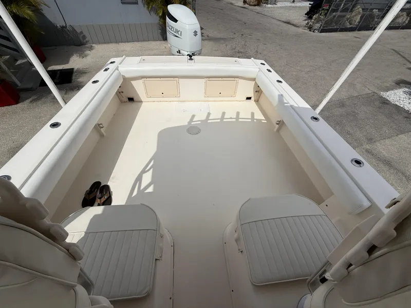 Slide: The Image of 2005 Parker 2510 Deep Vee Walkaround boat interior with seating and Suzuki outboard motor. - 19