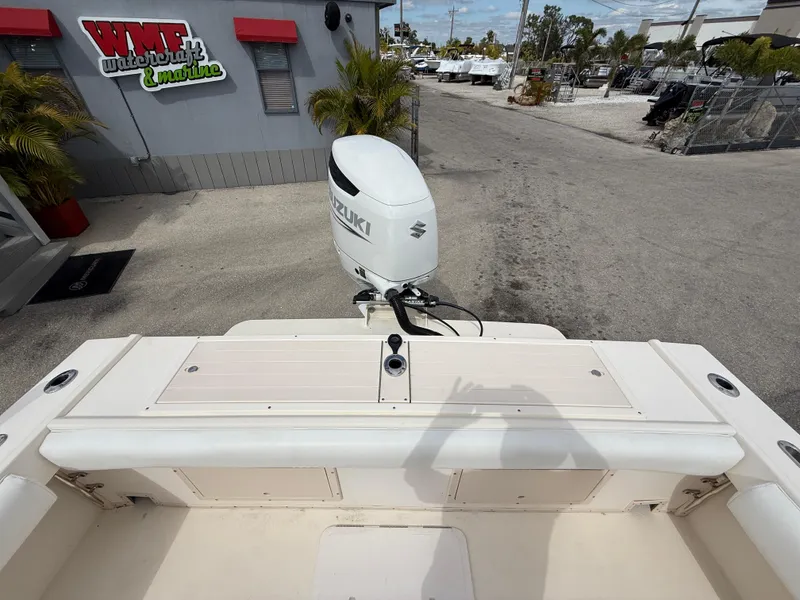 Slide: The Image of 2005 Parker 2510 Deep Vee Walkaround boat with Suzuki outboard motor, docked at a marina. - 20