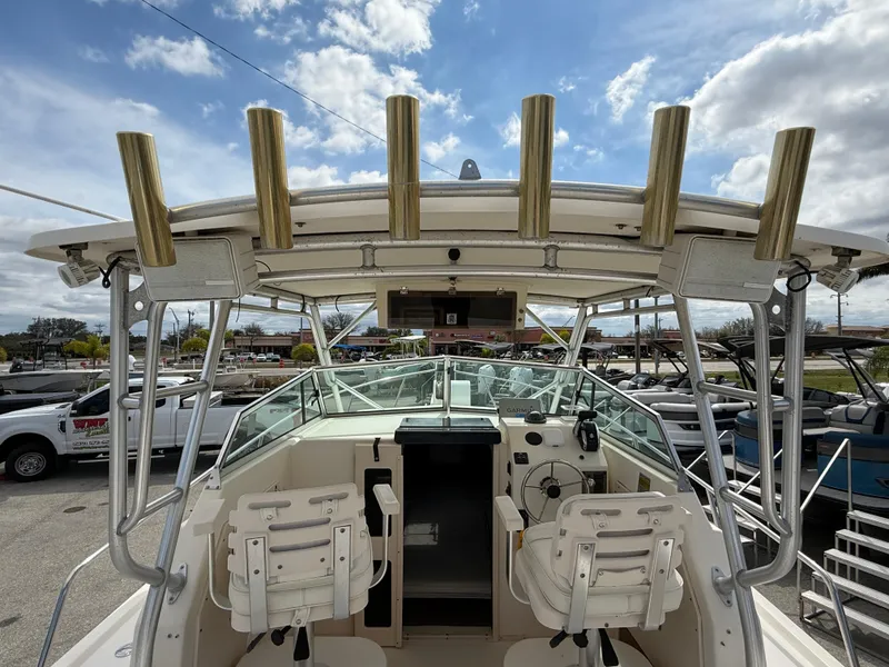 Slide: The Image of 2005 Parker 2510 Deep Vee Walkaround boat with dual seats and rod holders. - 21
