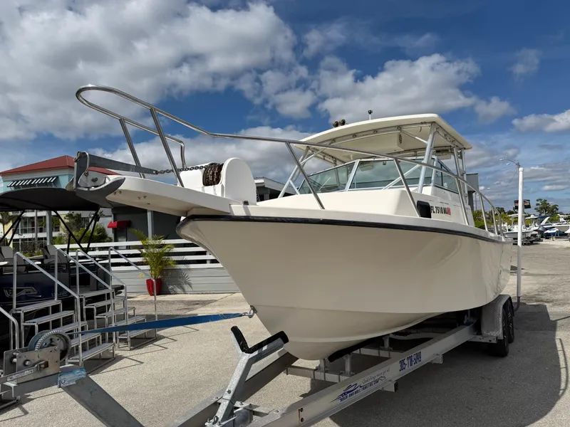 Slide: The Image of 2005 Parker 2510 Deep Vee Walkaround boat on trailer under blue sky. - 3