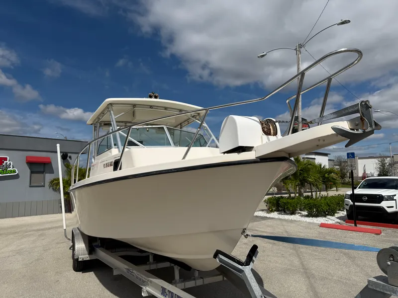 Slide: The Image of 2005 Parker 2510 Deep Vee Walkaround boat on trailer, parked outdoors. - 5